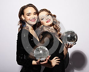 Party and people concept: Party girls with disco balls