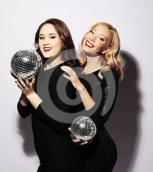 Party and people concept: Party girls with disco balls