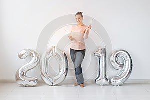 Party, people and new year holidays concept - woman celebrating new years eve 2019 with and sparklers