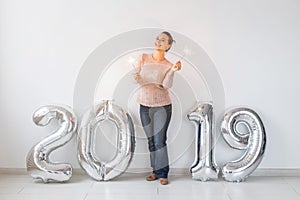 Party, people and new year holidays concept - woman celebrating new years eve 2019 with and sparklers