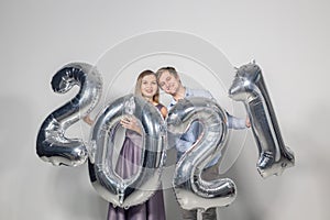 Party, people and new year holidays concept - woman and man celebrating new years eve 2021