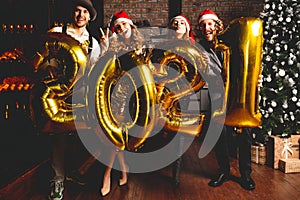 Party, people and new year holidays concept - women and men celebrating new years eve 2021.