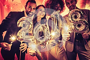 Party people women and men celebrating new years eve 2018