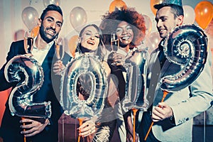 Party people women and men celebrating new years eve 2019