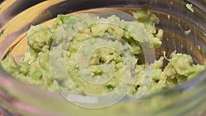 Party Snack - Mexican Nachos Chips dip Guacamole. Fresh healthy vegetarian dish of raw vegetables close-up