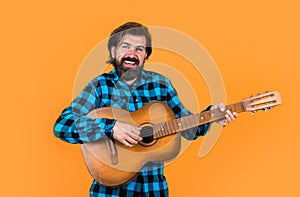 party string instrument player. mature singer musician. bearded man with acoustic guitar. brutal guy play the guitar