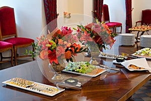 Party table setting decorated with flower bouquets, catering