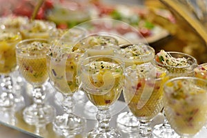 Cups with ceviche decorating the party table photo
