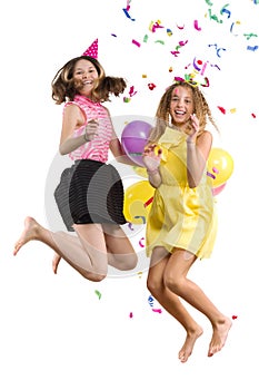 Party of teenage girls, girls with balloons, confetti in festive hats having fun, children are jumping, white background is isolat