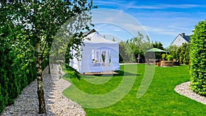 Party tent - garden party or wedding entertainment tent in modern garden