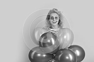 party woman with balloon in sunglasses. amazed woman hold party balloons in studio.