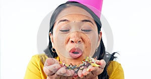 Party, woman face and blowing confetti in studio celebration for happy birthday, well done or good job on white