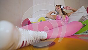 Party woman in pink outfit on bed