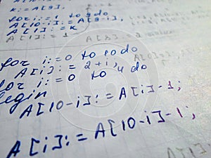 Pascal program written in a notebook. side view. the work of the programmer and sisadmida