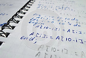 Pascal program written in a notebook. side view. the work of the programmer and sisadmida