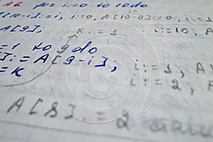 Pascal program written in a notebook. side view. the work of the programmer and sisadmida