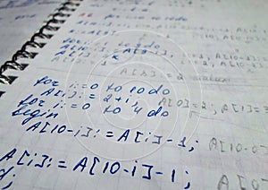 Pascal program written in a notebook. side view. the work of the programmer and sisadmida