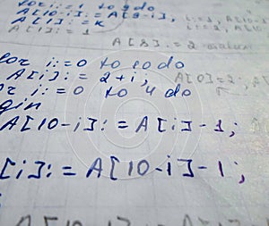 Pascal program written in a notebook. side view. the work of the programmer and sisadmida