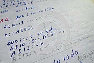 Pascal program written in a notebook. side view. the work of the programmer and sisadmida