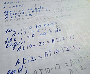 Pascal program written in a notebook. side view. the work of the programmer and sisadmida