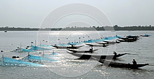 Pashur River near Mongla in Bangladesh. Fishing boats with nets on the river between the Sundarban Forest and Khulna
