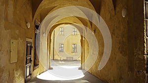 Passage with arcades leading through historic house, little alley