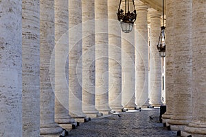 Passage between the columns in St. Peter`s Square in the Vatican