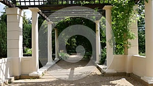 Passage through the garden colonnade with old columns