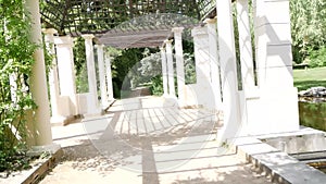 Passage through the garden colonnade with old columns