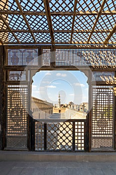 Passage surrounding Ibn Tulun Mosque framed by wooden perforated wall - Mashrabiya - Cairo, Egypt photo