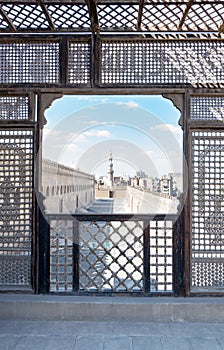 Passage surrounding the Mosque of Ibn Tulun framed by interleaved wooden perforated wall Mashrabiya photo