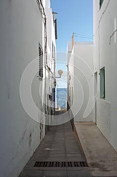 The passage to the ocean between the houses in the city in Arrieta on the island of Lanzarote photo