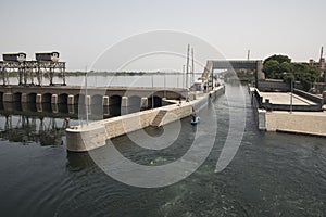 Passage of a tourist cruise through the lock of the Nile River at the height of the city of Esna in Egypt, Africa.