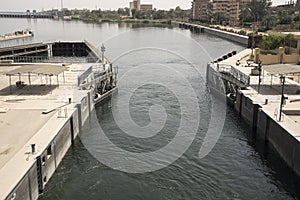 Passage of a tourist cruise through the lock of the Nile River at the height of the city of Esna in Egypt, Africa. photo