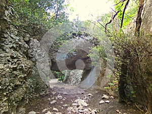 Passage under a large rock in the Regalon gorges in the Luberon in Provence