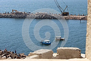 Passage way and fishermen near Citadel of Qaitbay, Egypt.