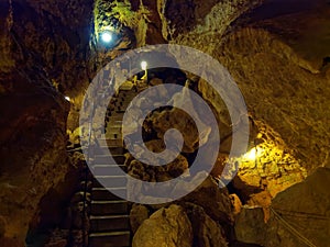 Passageway inside a pit cave with lights on, tourist attraction in Germany