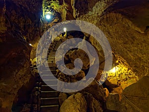 Passageway inside a pit cave with lights on, tourist attraction in Germany photo