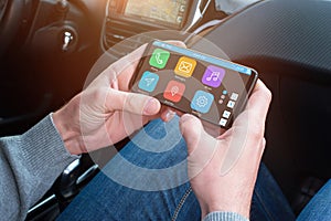 Passanger use mobile phone and app to help the driver find the desired location photo