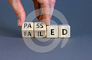 Passed or failed symbol. Businessman turns wooden cubes and changes the word `failed` to `passed` on a beautiful grey table, g