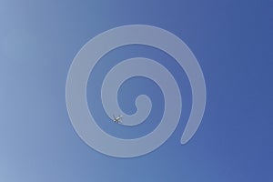 Passenger aiplane flying high on the blue sky
