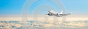 Passenger aircraft cloudscape with white airplane is flying in the daytime sky overcast, panorama view.