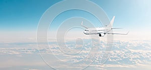 Passenger aircraft cloudscape with white airplane is flying in the evening sky overcast, panorama view.