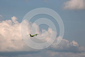 Passenger aircraft flying against cumulus cloud