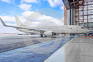 Passenger aircraft on maintenance of engine and fuselage repair in airport hangar. photo