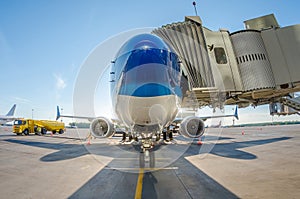 Passenger aircraft parked at the gangway at the airport at the refueling before the flight.