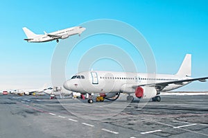 Passenger aircraft row, airplane parked on service before departure at the airport. One aircraft take off to runway in the cloudy