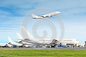 Passenger aircraft row, airplane parked on service before departure at the airport, other plane push back tow. One two-story airpl