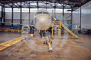 Passenger aircraft on service in an aviation hangar