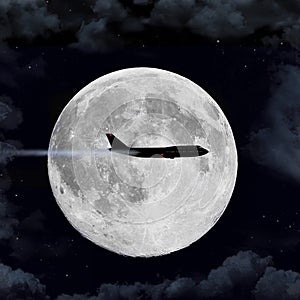 An passenger airliner airplane flies in front of a full moon